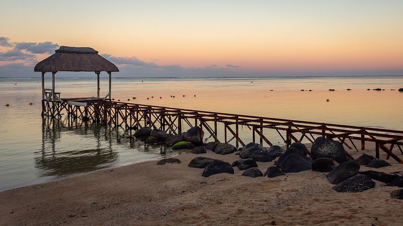 Wooden jetty at Bel Ombre beach at sunset